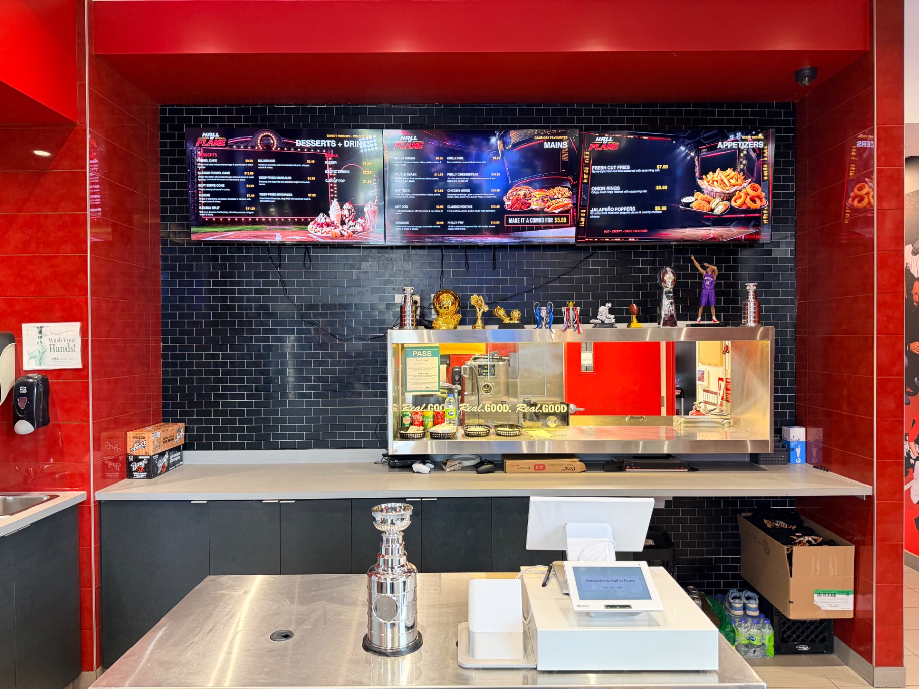 Hall of Flame counter with menu screens, trophies and red arena styling